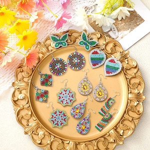 Detail of colorful DIY diamond painting earrings in butterfly and heart shapes
