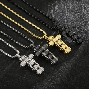 Detail of cross pendants with bike chain design in four colors on black background