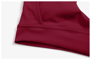 Detail of burgundy yoga top showing premium double-needle stitching and elastic fabric