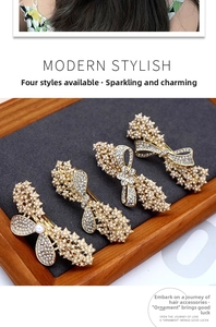 Detailed view of four pearl and rhinestone hair clips on a wooden tray and grey velvet board