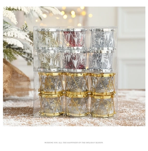 Detail of glittery Christmas drum ornaments in gold, silver, and red for festive tree decor