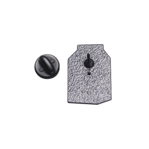 Detail view of colorful metal juice badge with black rubber pin back on white background