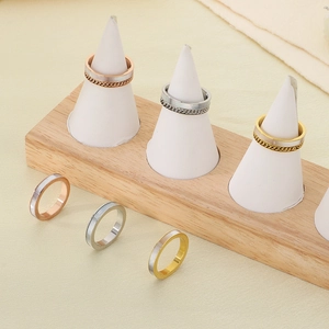 Fashionable metal shell rings in gold and silver finish on display stands