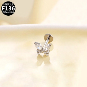 Macro detail of butterfly labret stud made from sterile F136 titanium and white zircon stones