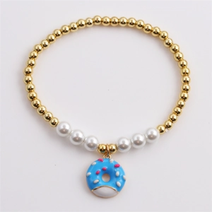 Elegant beaded bracelet with gold copper beads, white pearls and blue donut pendant
