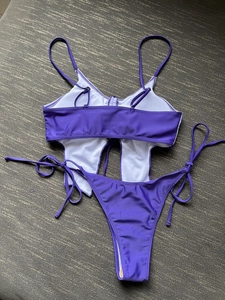 Flat lay of purple butterfly bikini set showing side-tie bottom and bandeau top texture