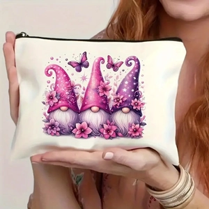 Close-up of white canvas makeup bag featuring three garden gnomes and floral motifs