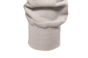 Macro shot of high-quality beige ribbed knit cuffs on a men's business cardigan