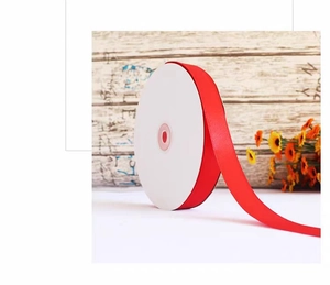 Detail view of 2cm red matte polyester ribbon roll for gift wrapping and cake decoration