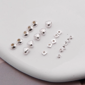 Detailed view of S925 sterling silver beads in round, heart, and square shapes for DIY jewelry