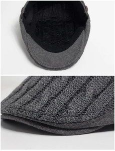 Macro view of dark grey knitted beret with cable pattern and breathable inner lining
