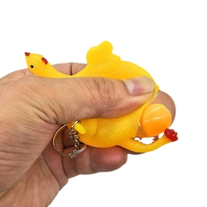 Funny squeeze chicken keychain toy showing creative egg laying stress relief action