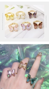 Macro detail of gold finish butterfly ring with purple crystal and adjustable open band