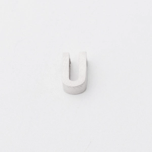 Close-up of polished silver-tone U-shaped metal letter beads for personalized jewelry