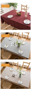 Close-up of checkered tablecloths with fringe in red, gray, and brown linen fabric