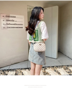 Detail of cream crossbody bag with V-quilted texture and branded wide woven strap