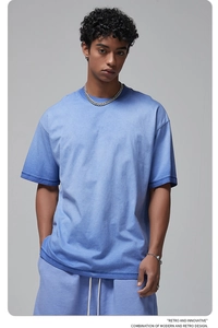 Detail of washed blue retro cotton T-shirt featuring dropped shoulders and relaxed fit