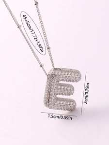 Close-up of letter E pendant necklace with micro-pave zircons and size measurements