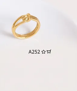 Macro shot of 18K gold plated minimalist knot ring with a polished metal finish