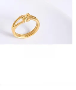 Macro shot of 18K gold plated minimalist knot ring with a polished metal finish