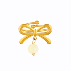 Detail of a golden bow open ring featuring a hanging cream round pearl on a white background
