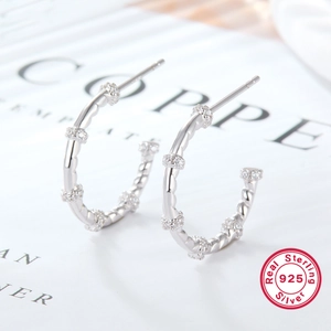 Elegant 925 sterling silver twist hoop earrings with sparkling white cubic zirconia