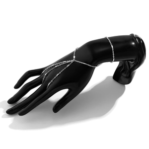 Close-up of silver finger ring bracelet with pearl accents and link chain on hand model