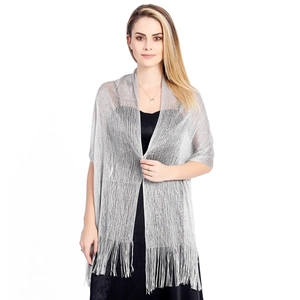 Close-up of metallic silver shawl with long fringe details for evening party wear