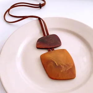 Vintage irregular amber resin geometric pendant necklace with brown leather cord