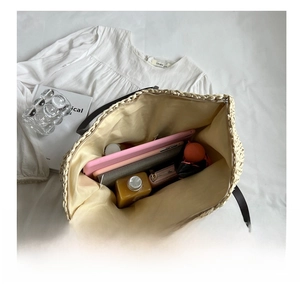 Interior view showing large storage capacity of the woven tote bag with daily items