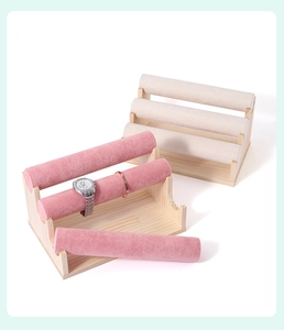 Three-tier wood base jewelry display stand with pink and beige velvet T-bars for watches