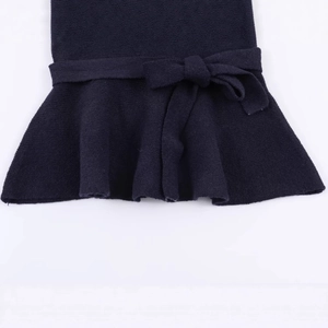 Navy blue knit top featuring a waist bow tie and stylish ruffled peplum hem design