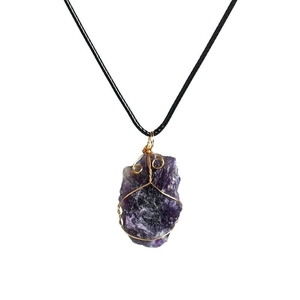 Raw amethyst pendant necklace with gold wire wrapping and simple black rope cord