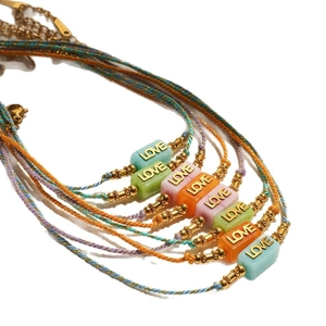 Colorful woven rope bracelets with LOVE letter beads and metal accents in a 7-piece set