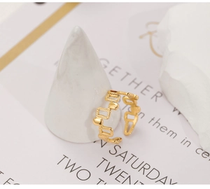 Detail of 18k gold plated irregular geometric open ring on minimalist display stand