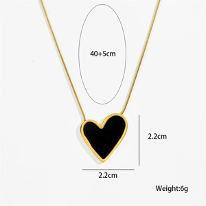Detail view of 18K gold heart pendant with black enamel and specific size dimensions