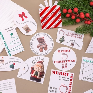 Variety of Christmas gift tags with festive patterns like Santa and teddy bears on beige background