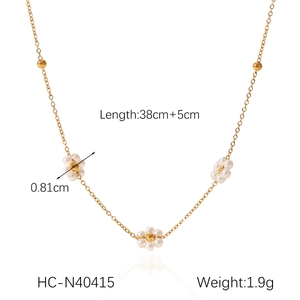 Detail of vintage flower necklace with freshwater pearls and golden stainless steel beads