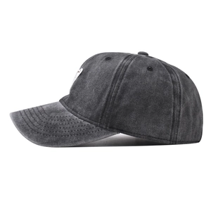 Close-up of distressed dark grey washed cotton baseball cap with white bear embroidery