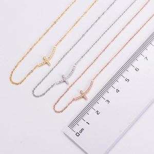 Detailed comparison of gold, silver, and rose gold cross necklaces with measurement scale