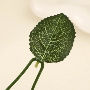 Detailed macro view of artificial green leaves with realistic vein textures for disco ball cherry