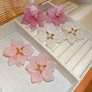 Sweet acrylic flower earrings with pearl centers in pink and white, arranged in a jewelry box