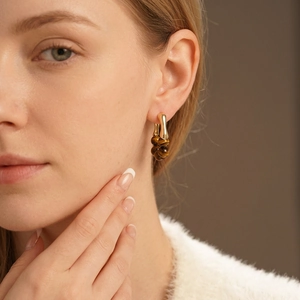 Elegant gold plated tiger eye beaded earrings on model in vintage Maillard style