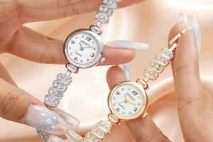 Close-up of gold and silver quartz watches with crystal accents and chain bracelets