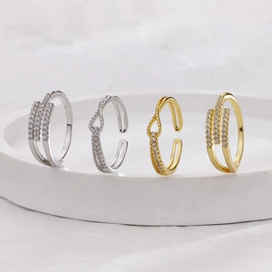 Adjustable gold and silver rings with cubic zirconia pavé in crossover and triple row designs