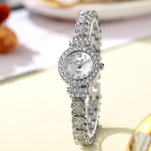 Macro shot of silver quartz watch with full rhinestone accents and white dial