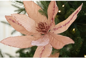 Close-up of rose gold velvet poinsettia with glitter and sequins for Christmas tree decor