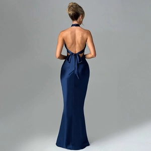 Detailed back view of a navy satin evening gown featuring an open back and large bow tie