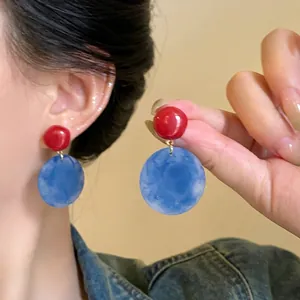 Elegant resin drop earrings with red studs and blue marble pendants for a chic vintage look