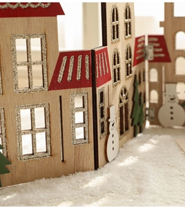 Detail of wooden Christmas house fence decoration with silver glitter and snowman motifs